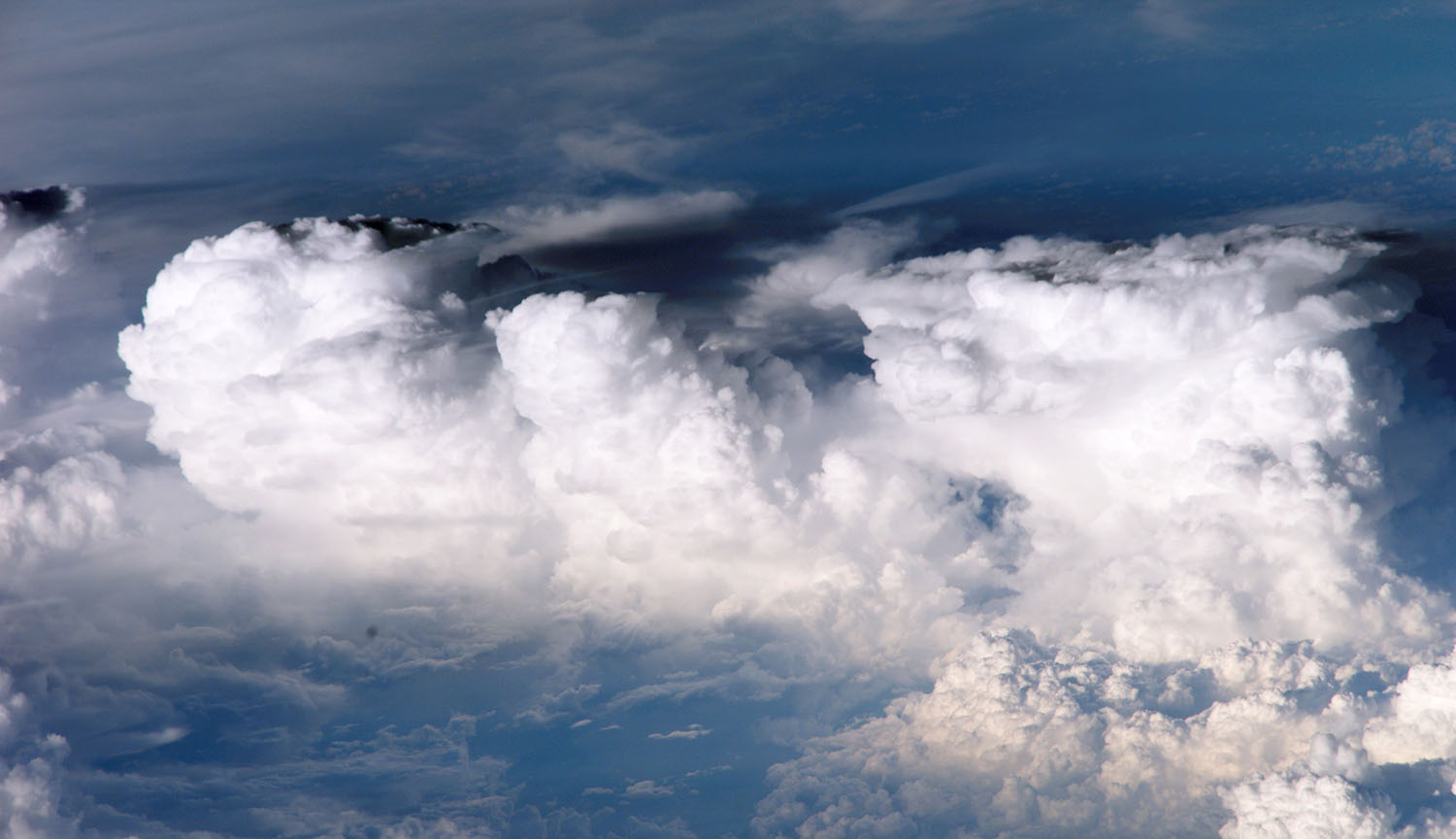Photograph of several large clouds clumped together.