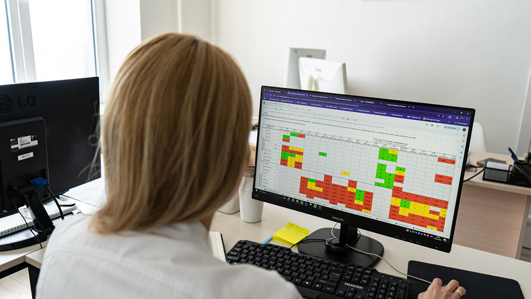 An over-the-shoulder-look at a computer screen showing a color-coded table.